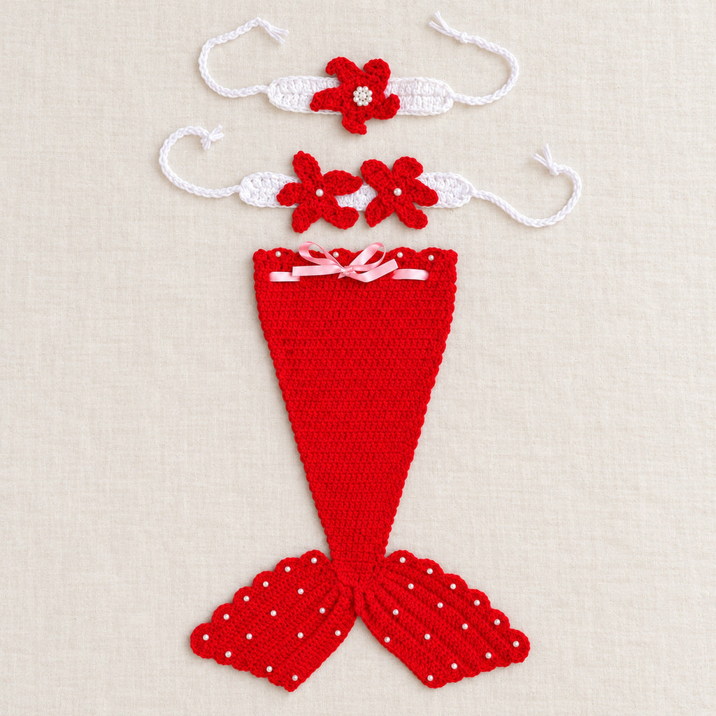 Red mermaid tail and two matching accessories laid separately