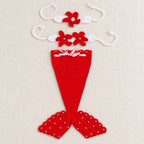 Red mermaid tail and two matching accessories laid separately