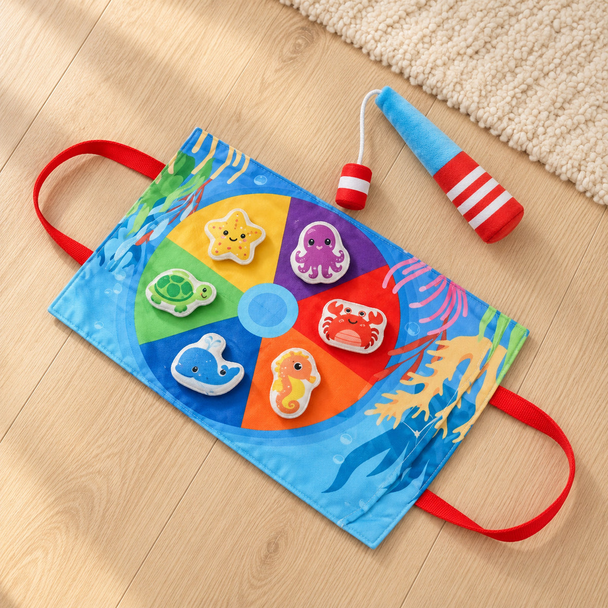 Lumiwee Minnow Mini fishing set with six fabric sea animals, one rod and pond mat on pale oak floor