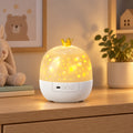 Lumiwee Nova crown-topped projector glowing warm yellow on an oak dresser