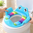 Adult hands fitting the blue training seat on a lowered toilet seat