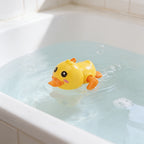 Lumiwee Paddle wind-up bath toy: yellow wind-up duck bath toy paddling in the tub