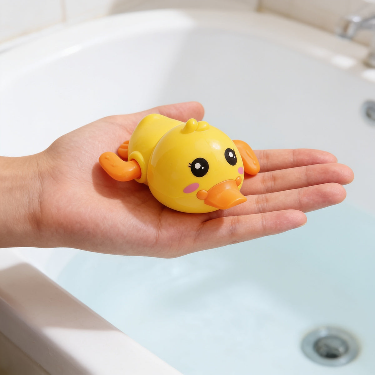 Lumiwee Paddle wind-up bath toy: the duck toy on an open palm for scale