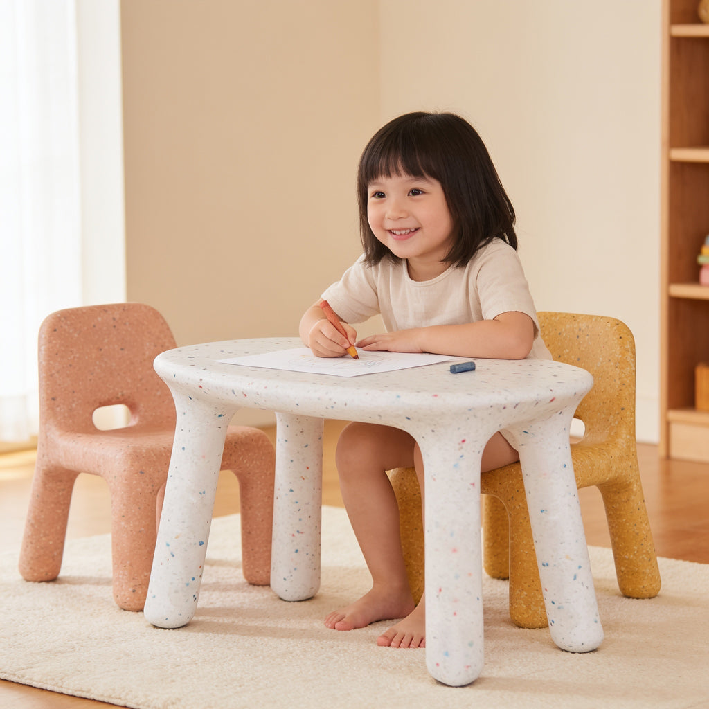 Lumiwee Pebble kids table and chair set: toddler drawing at the table, sitting on the yellow chair