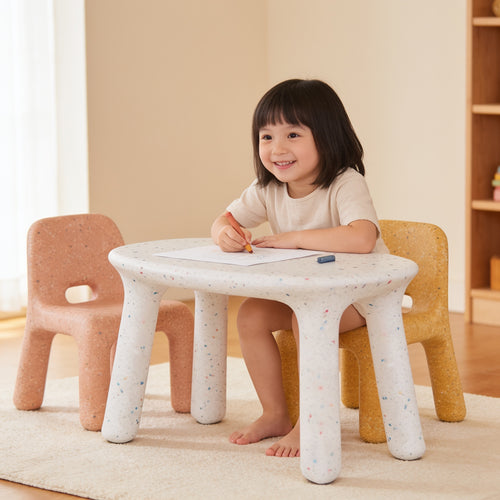 Lumiwee Pebble kids table and chair set: toddler drawing at the table, sitting on the yellow chair