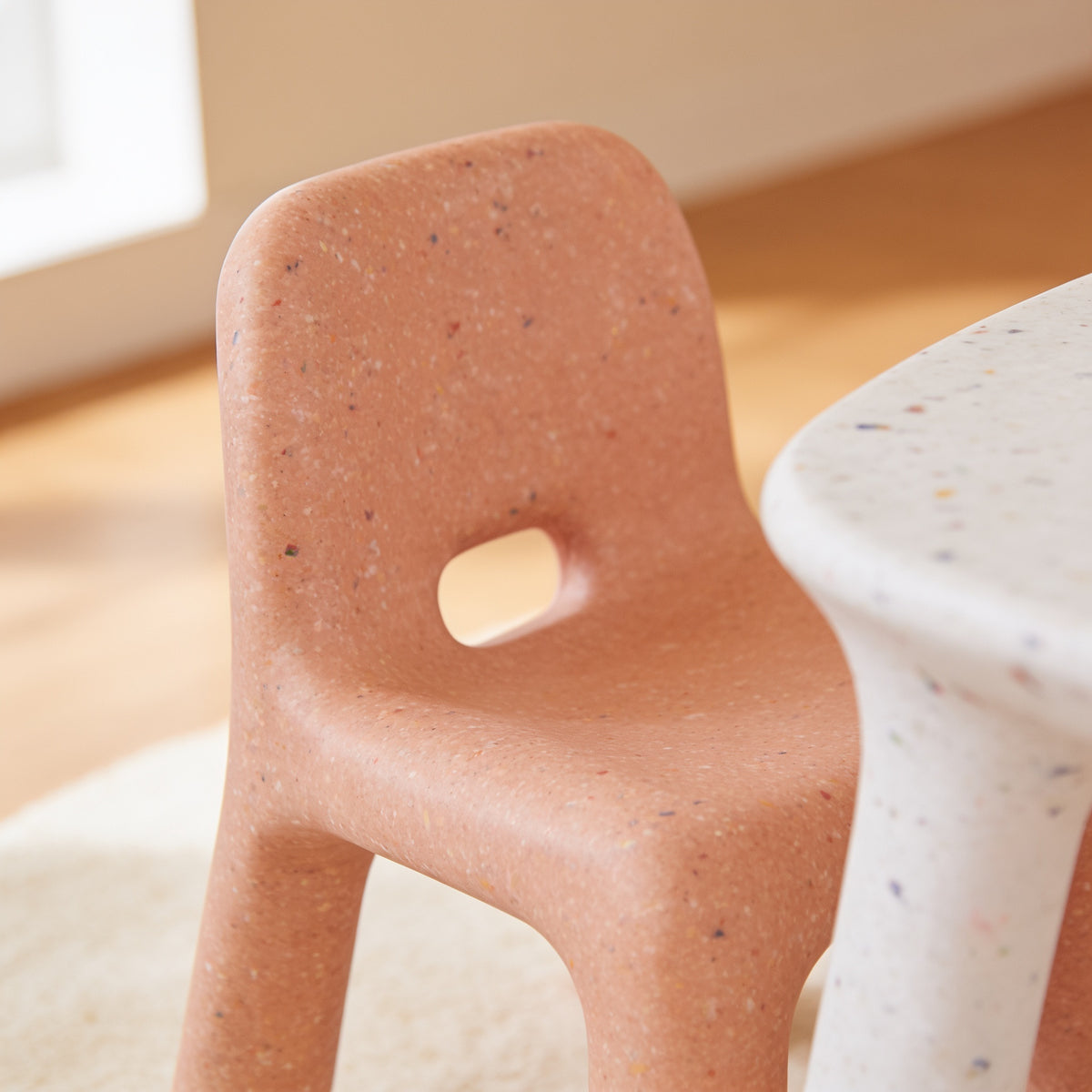 Lumiwee Pebble kids table and chair set: close-up of the chair backrest hand hole and speckled finish