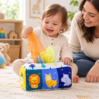 Awake toddler pulling a scarf from the Animals tissue box toy beside a parent