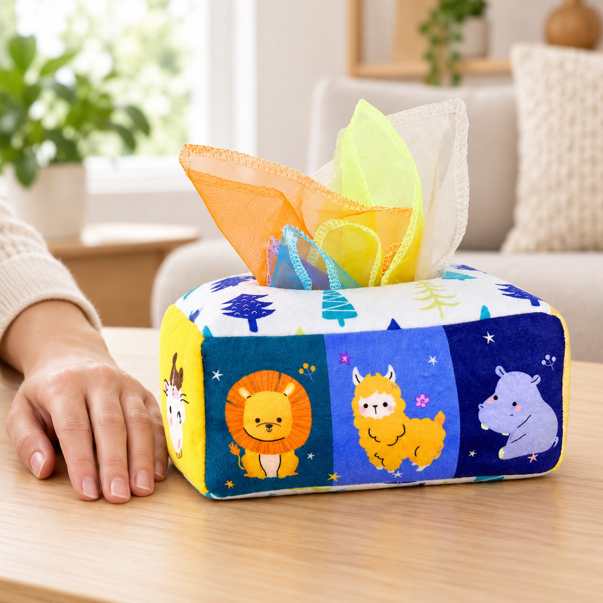 Animals tissue box toy beside an adult hand for scale