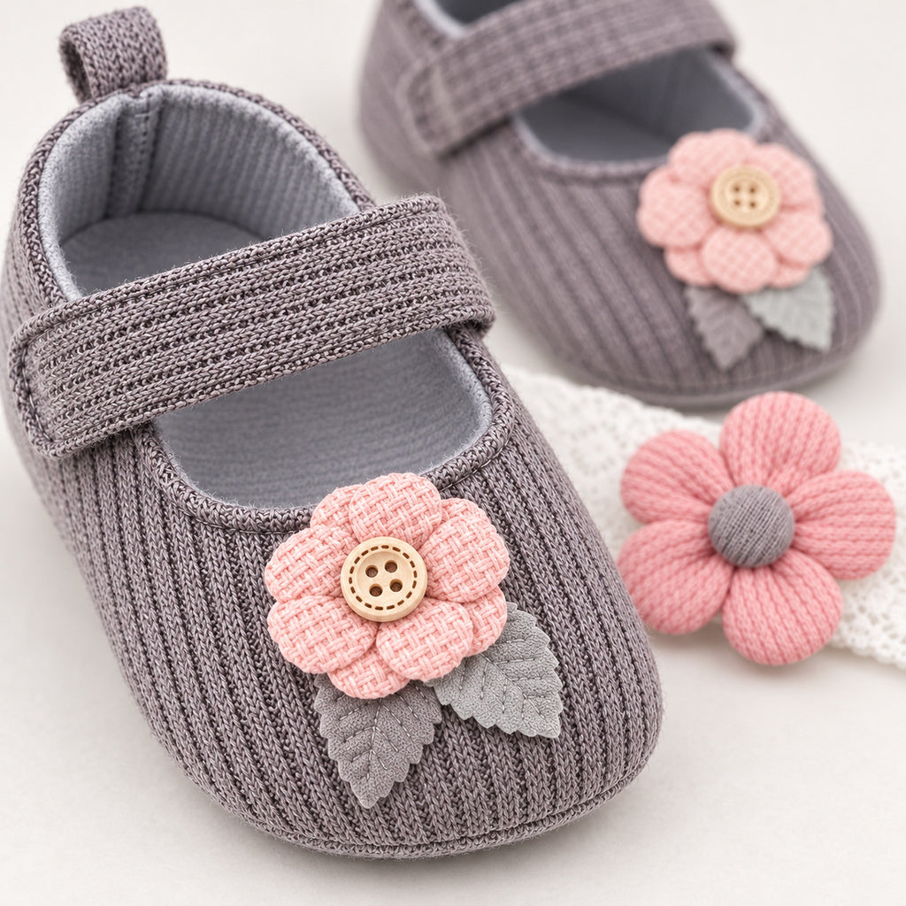 Close-up of the gray shoe's knit strap and pink button flower