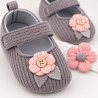 Close-up of the gray shoe's knit strap and pink button flower