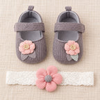 Gray button-flower shoe set with one matching headband laid flat