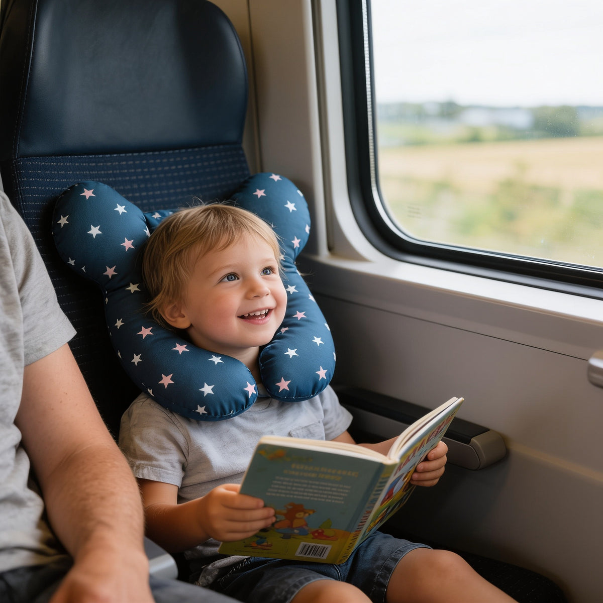 Lumiwee Pip toddler U-shaped travel pillow: toddler in a train seat wearing the blue star travel pillow