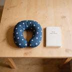Lumiwee Pip toddler U-shaped travel pillow: the pillow next to a paperback for scale