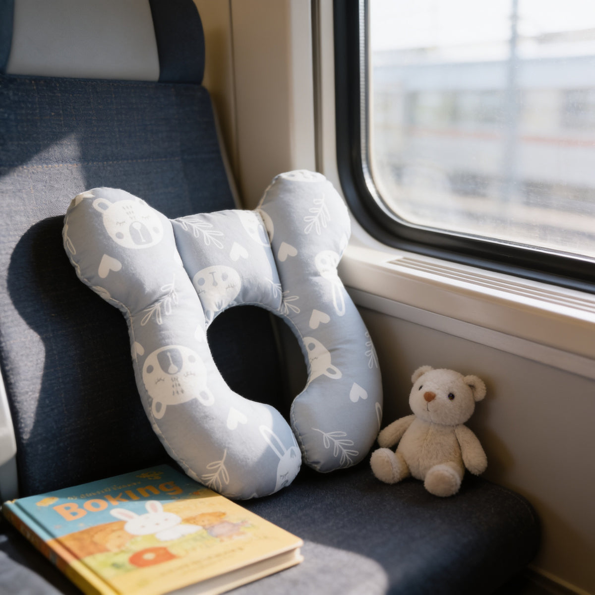 Lumiwee Pip toddler U-shaped travel pillow, Rabbit option, in a bright room