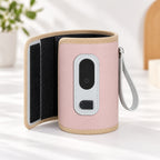 Pink warmer sleeve opened to show its inner wrap and closure, with wrist strap attached
