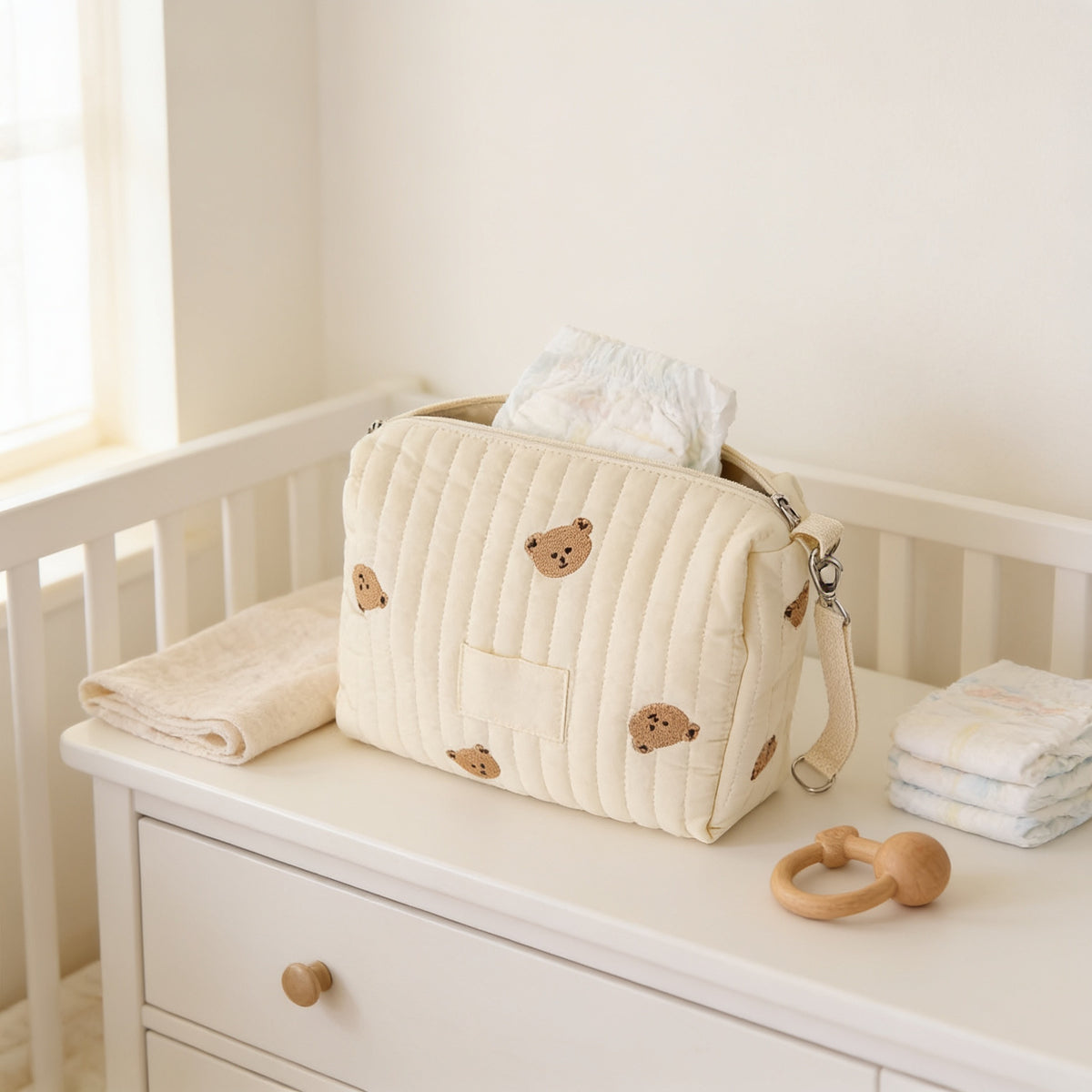 Lumiwee Posy embroidered diaper pouch: cream quilted bear pouch on a nursery dresser with diapers
