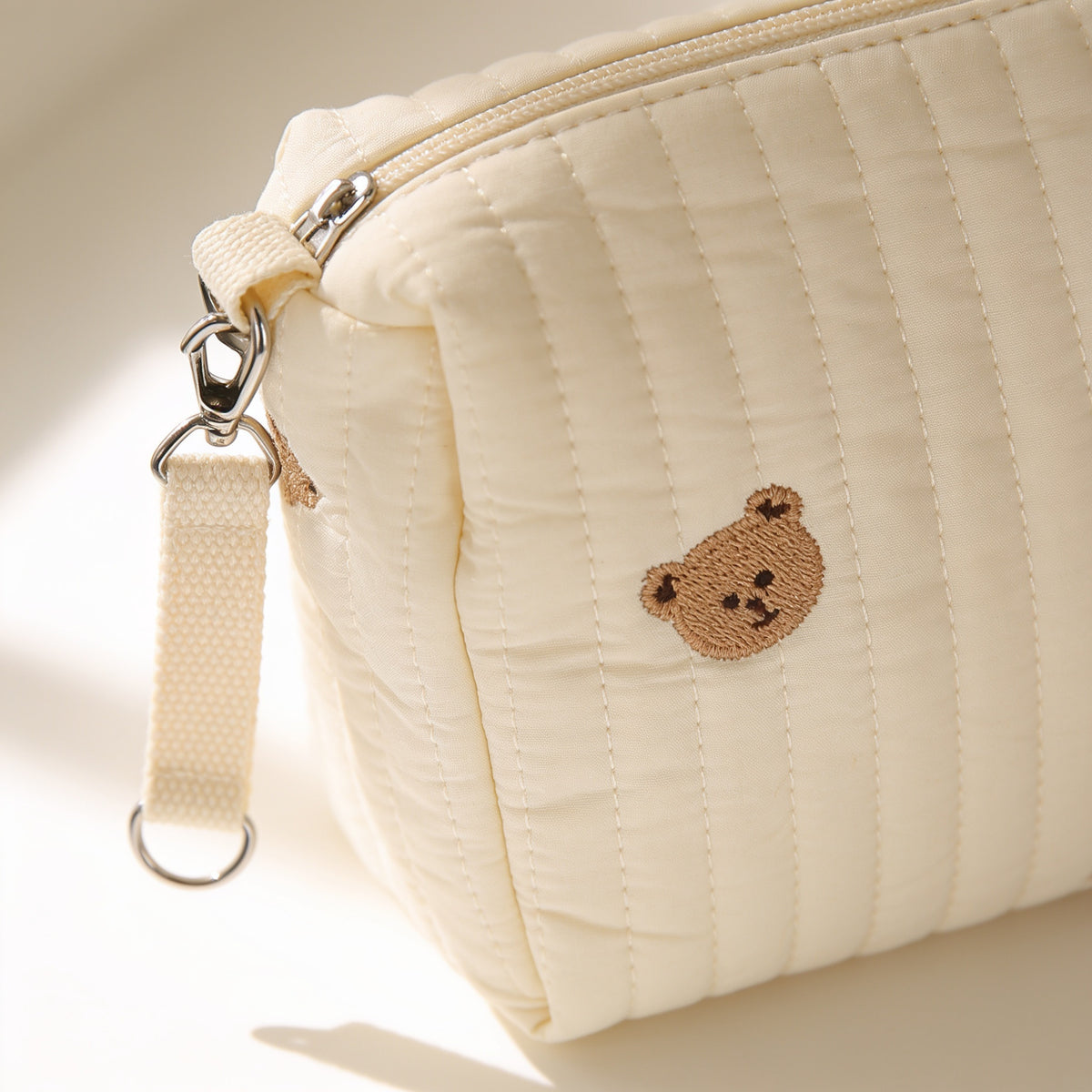 Lumiwee Posy embroidered diaper pouch: close-up of the quilted channels and embroidered bear
