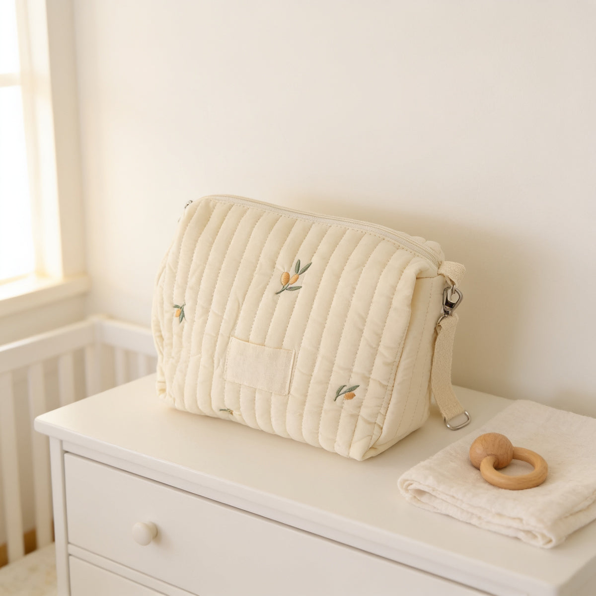 Lumiwee Posy embroidered diaper pouch, Olive Branch option, in a bright room