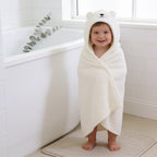 Lumiwee Puddle hooded baby bath towel: toddler wrapped in the polar bear hooded towel after a bath
