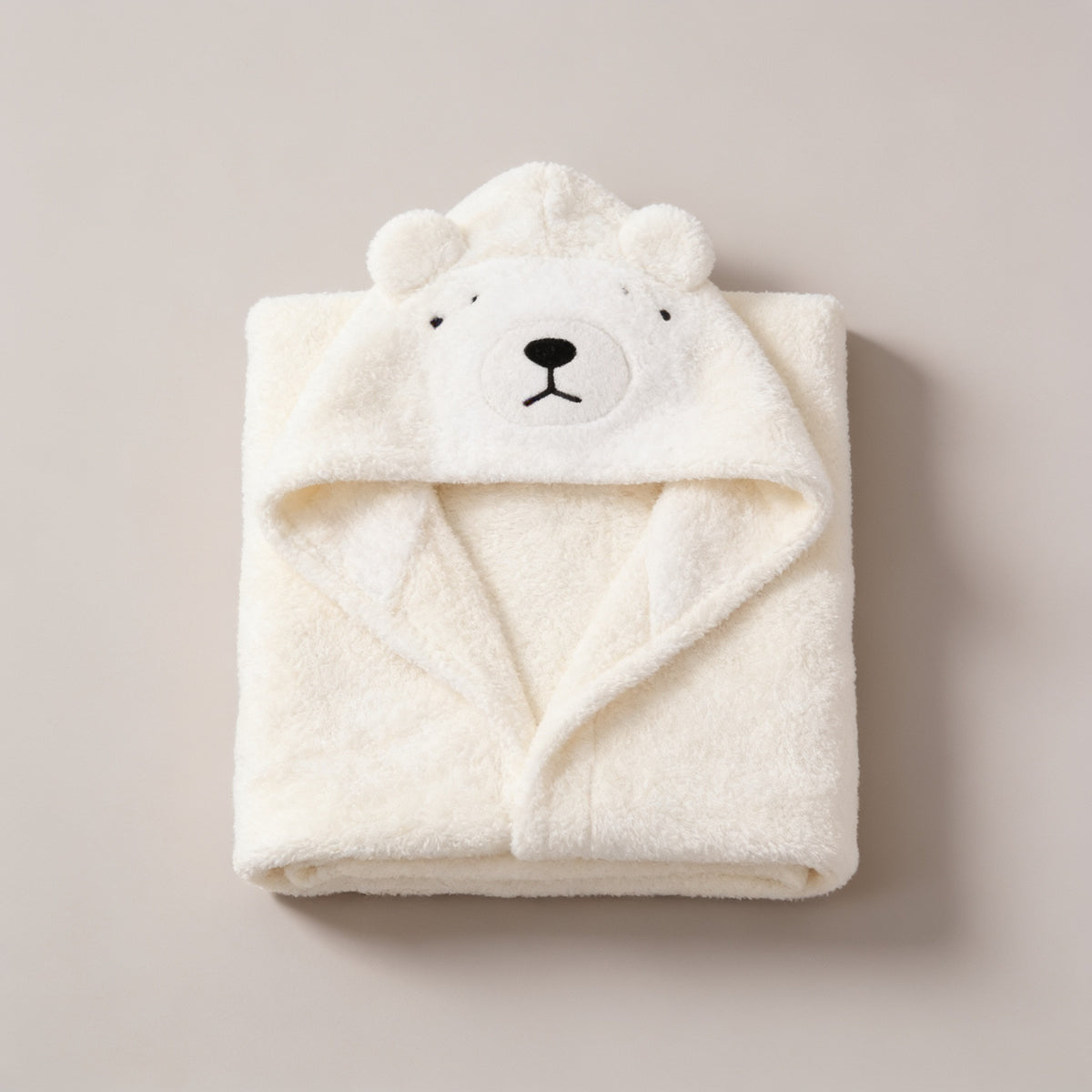 Lumiwee Puddle hooded baby bath towel: cream polar bear hooded baby towel on a plain background