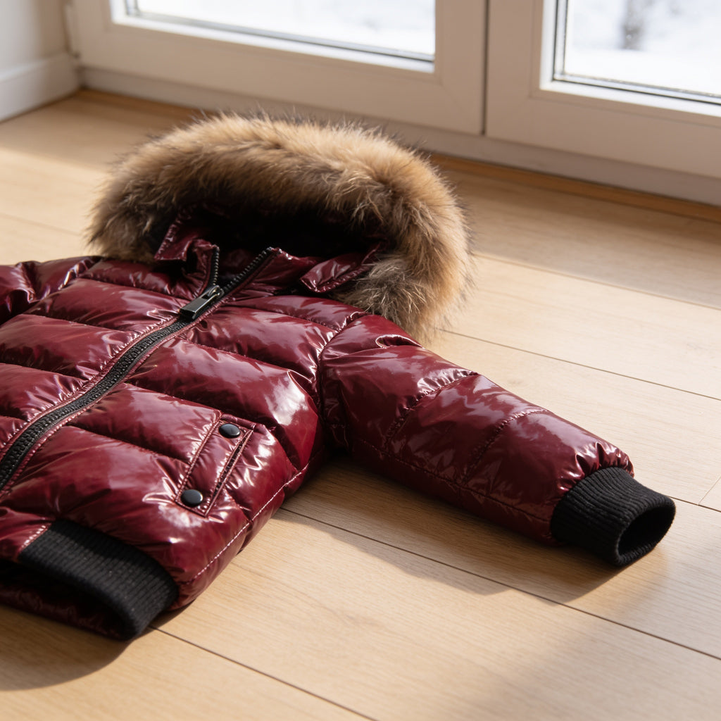 Lumiwee Puffin kids hooded puffer jacket: close-up of the glossy quilted baffles, hood trim and rib cuff