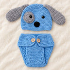 Blue and gray puppy crochet hat and diaper cover styled on ivory linen