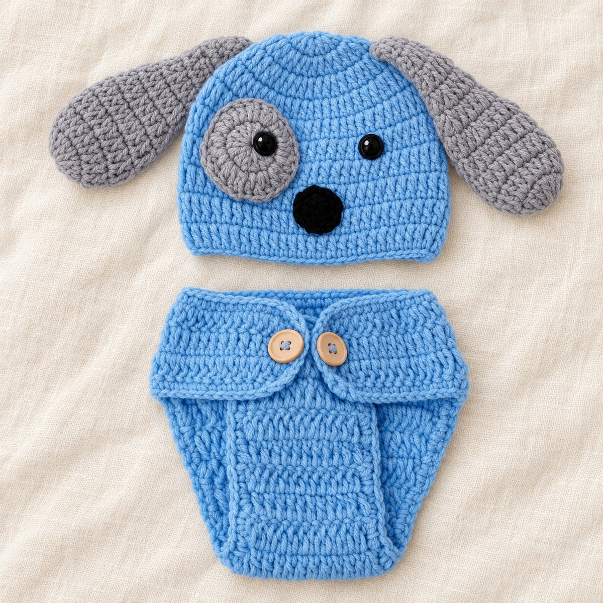 Blue and gray puppy crochet hat and diaper cover styled on ivory linen