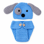 One puppy hat and one buttoned diaper cover laid flat