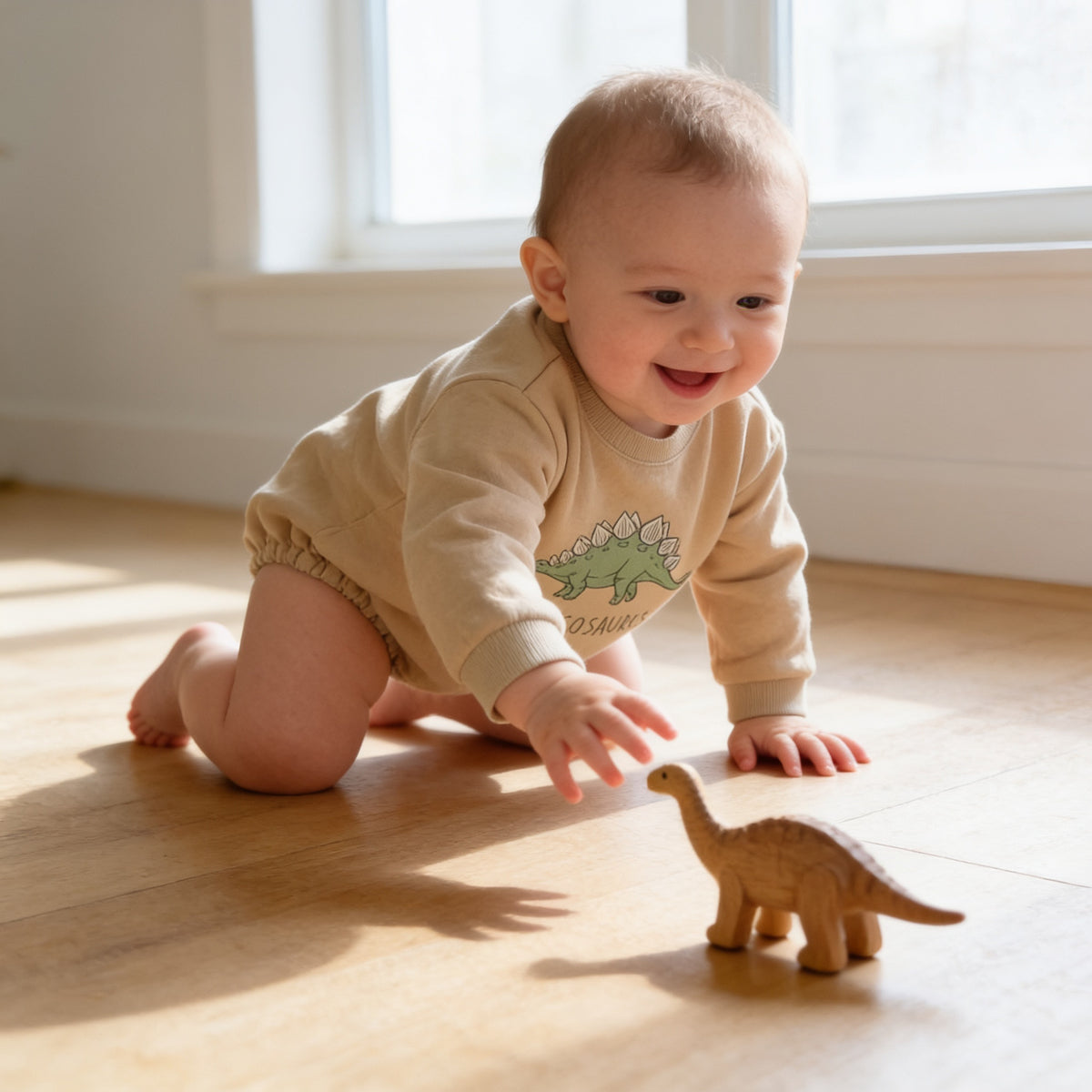 Lumiwee Rex dinosaur baby bodysuit: baby crawling in the stegosaurus romper