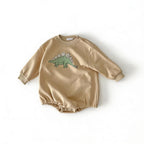 Lumiwee Rex dinosaur baby bodysuit: beige stegosaurus baby romper on a white background