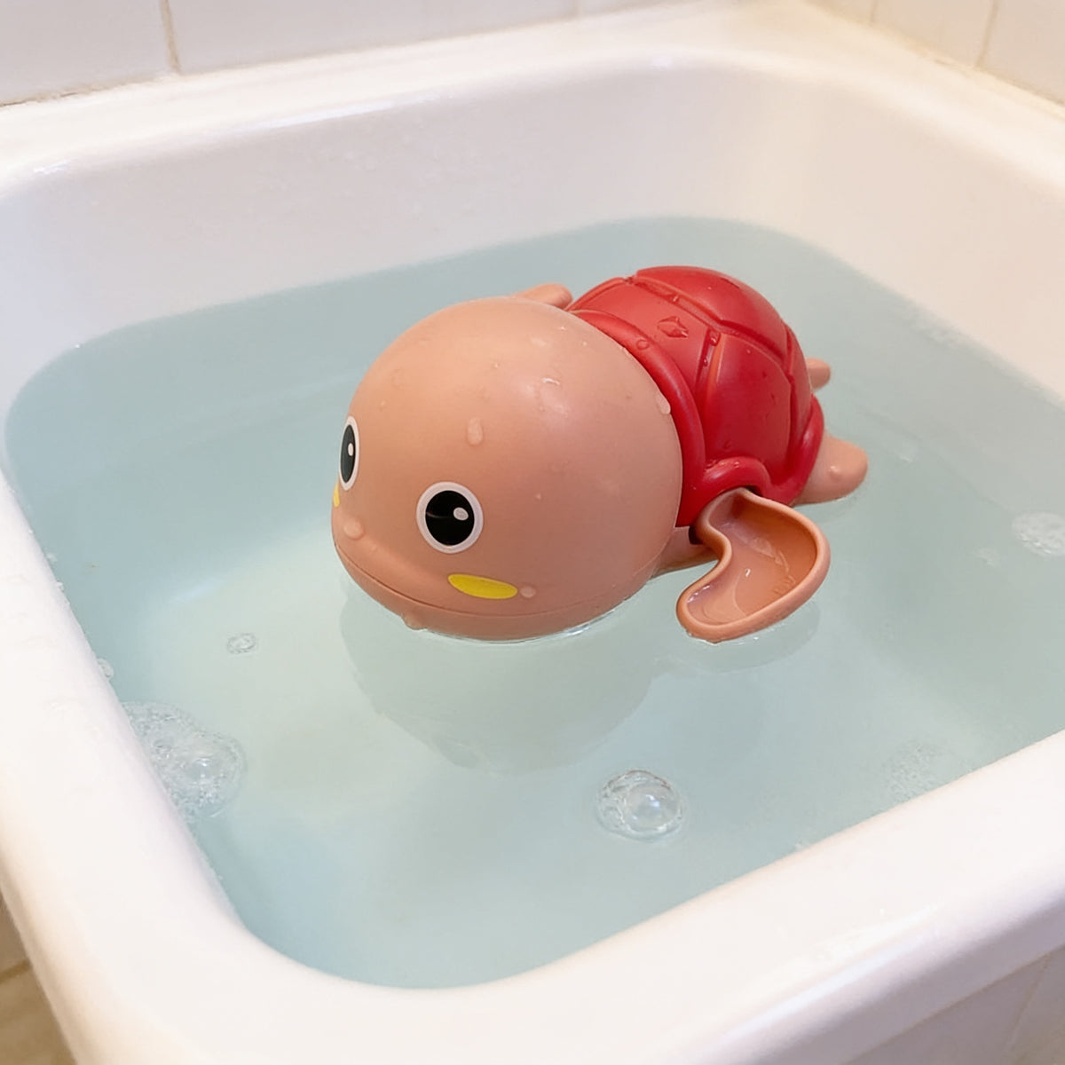 Lumiwee Ripple toddler bath toys, Pink Turtle Swimmer option, in a bright room