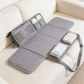 Lumiwee Robin portable changing pad: gray portable changing pad unfolded on a sofa