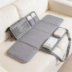 Lumiwee Robin portable changing pad: gray portable changing pad unfolded on a sofa