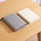 Lumiwee Robin portable changing pad: folded pad next to a paperback for scale