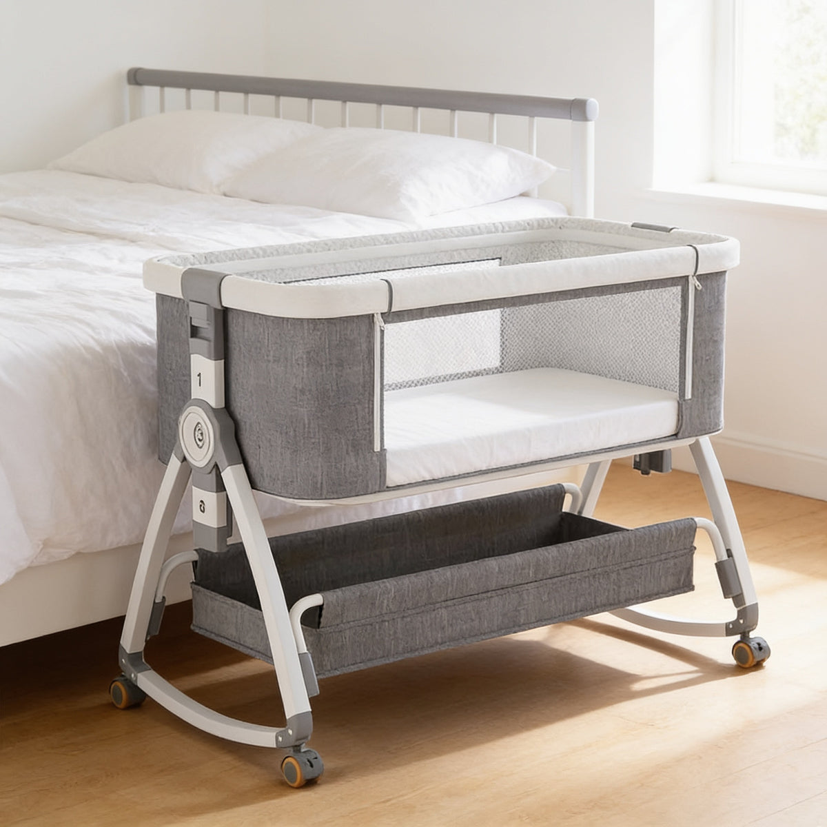 Lumiwee Rowan bedside baby crib: empty grey bedside crib beside a made adult bed