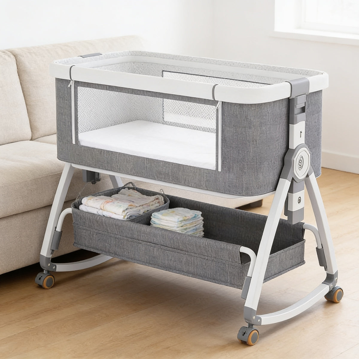 Lumiwee Rowan bedside baby crib: bedside crib on wheels in a living room with a stocked basket