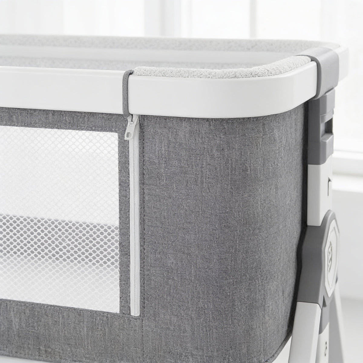 Lumiwee Rowan bedside baby crib: close-up of the grey fabric, mesh window and padded rail