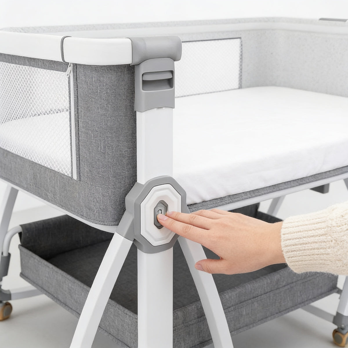 Lumiwee Rowan bedside baby crib: pressing the leg button to adjust the height