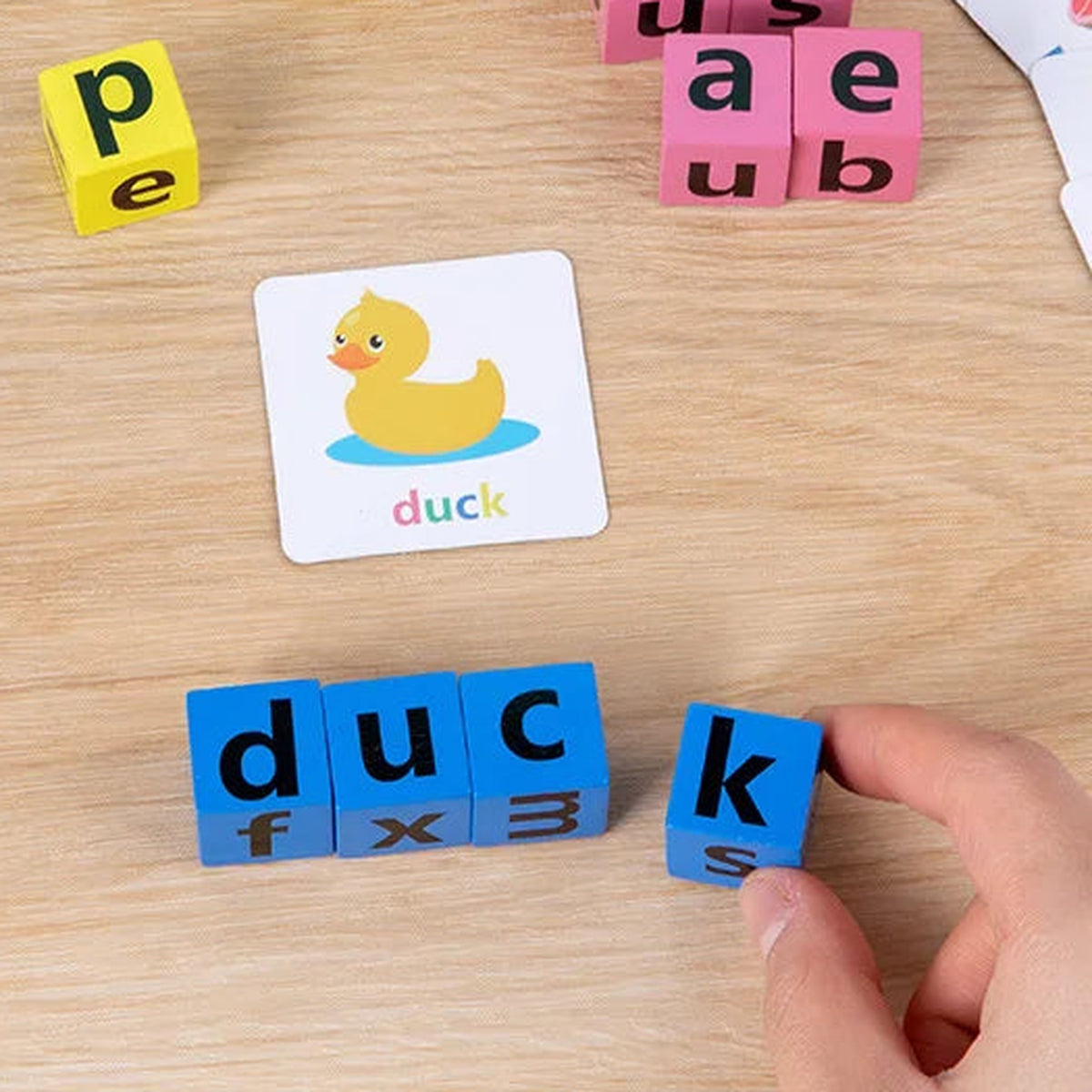 Lumiwee Scribble adult turning a blue letter block to spell duck