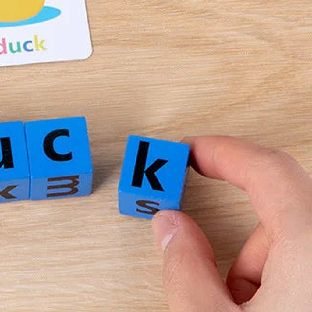 Lumiwee Scribble small letter block held between adult fingers for scale