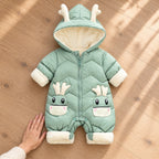 Lumiwee Sleet green snowsuit beside an adult hand for scale