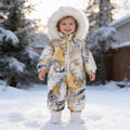 Lumiwee Snowdrop toddler hooded snowsuit: toddler in the painted waves hooded snowsuit standing in the snow