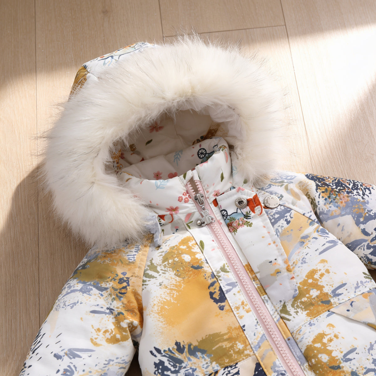 Lumiwee Snowdrop toddler hooded snowsuit: close-up of the fluffy hood trim, front zipper and snap