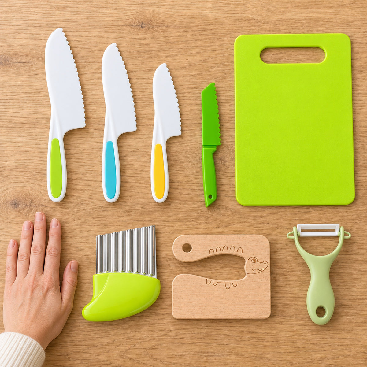 Lumiwee Sous complete eight-piece kitchen set beside an adult hand for scale