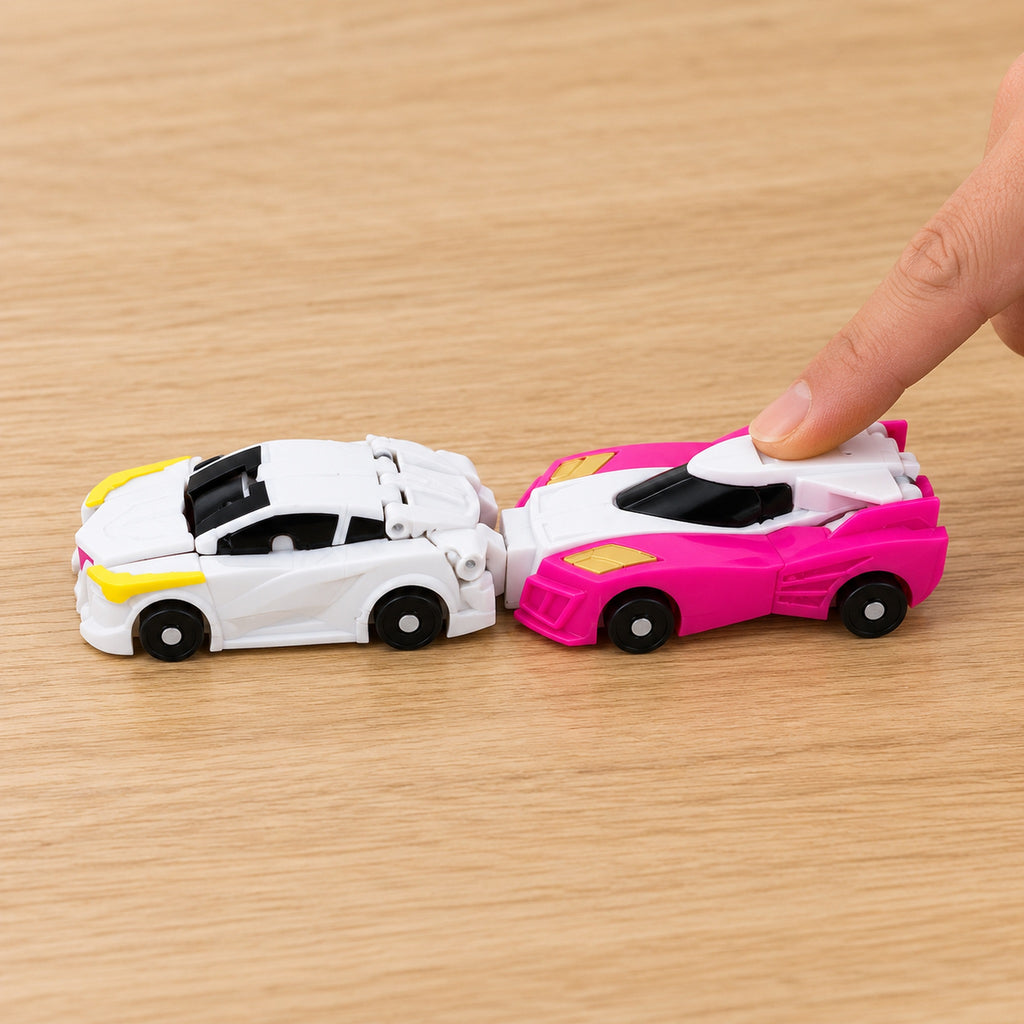 Adult finger pushing the pink car into the rear of the white car