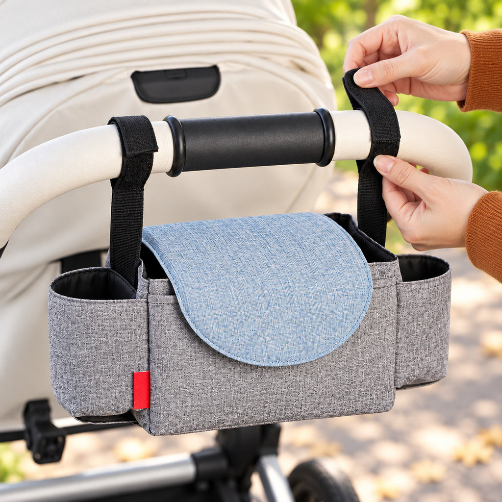 Adult securing a Sparrow hook-and-loop strap around a stroller handlebar