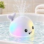 Spout white whale glowing and spraying a fountain in shallow bath water