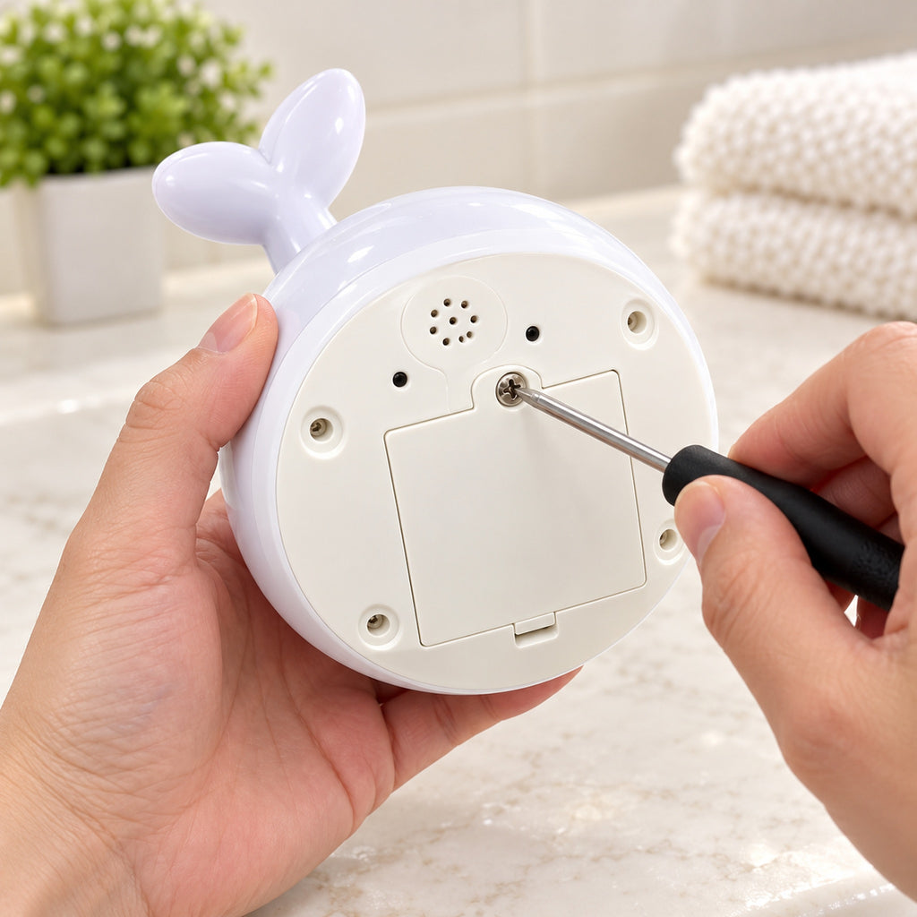 Adult tightening the screw on Spout dry underside battery cover