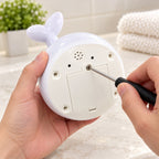 Adult tightening the screw on Spout dry underside battery cover