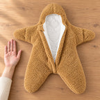 Empty Starfish bunting beside an adult palm on an oak table